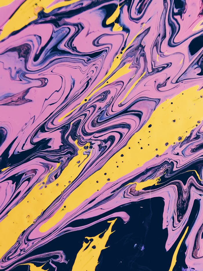 Colorful abstract paint swirl pattern with vibrant yellow and pink tones.